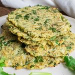 cauliflower egg wraps on a white plate with pieces of cilantro