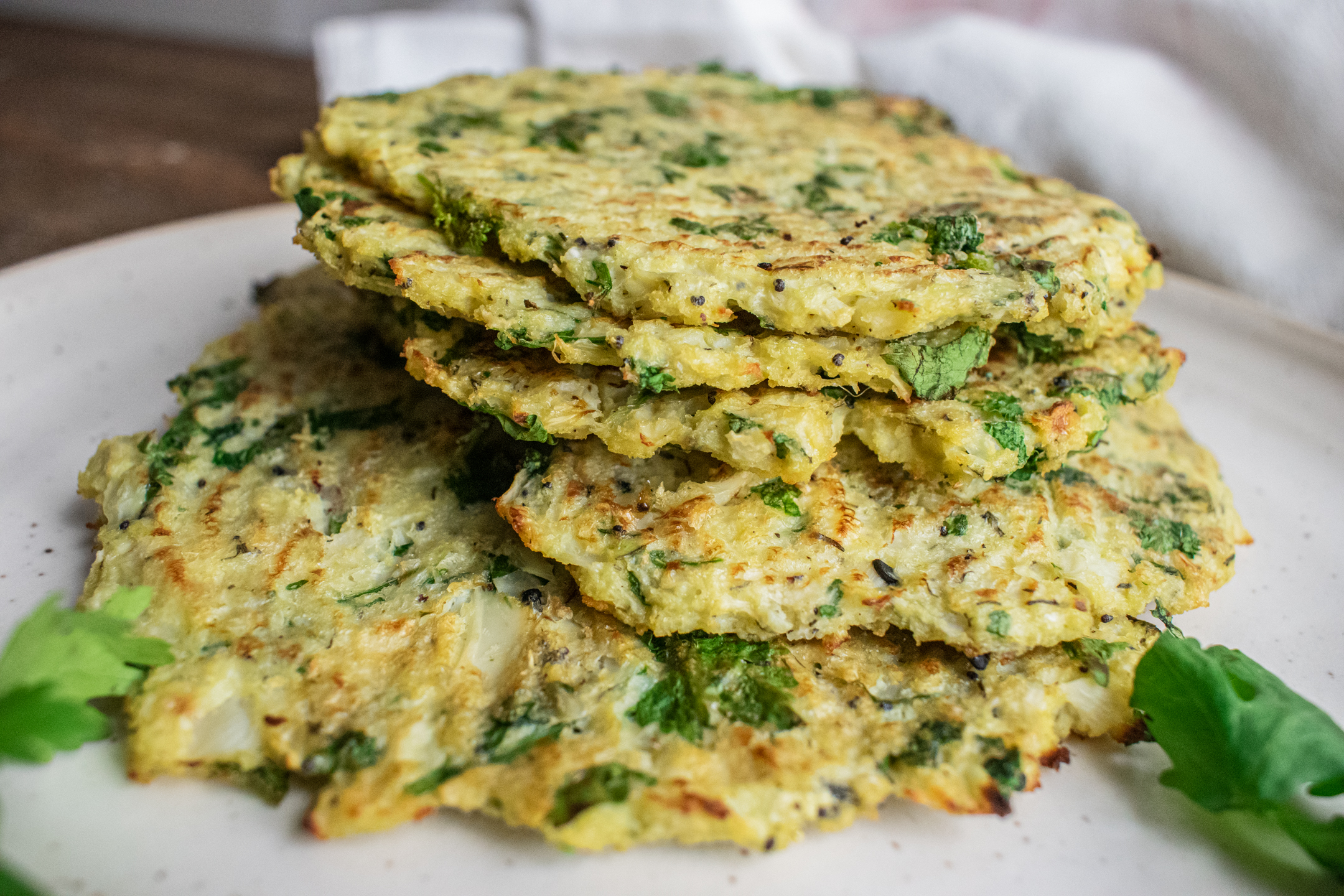 a pile of cauliflower egg wraps sitting on a white plate