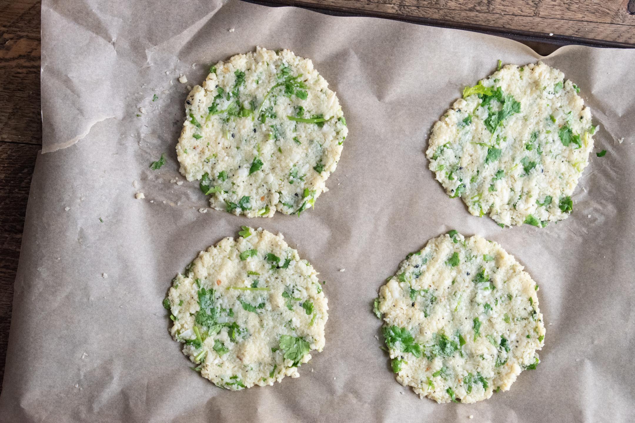 cauliflower egg wraps on a parchment paper lined baking tray