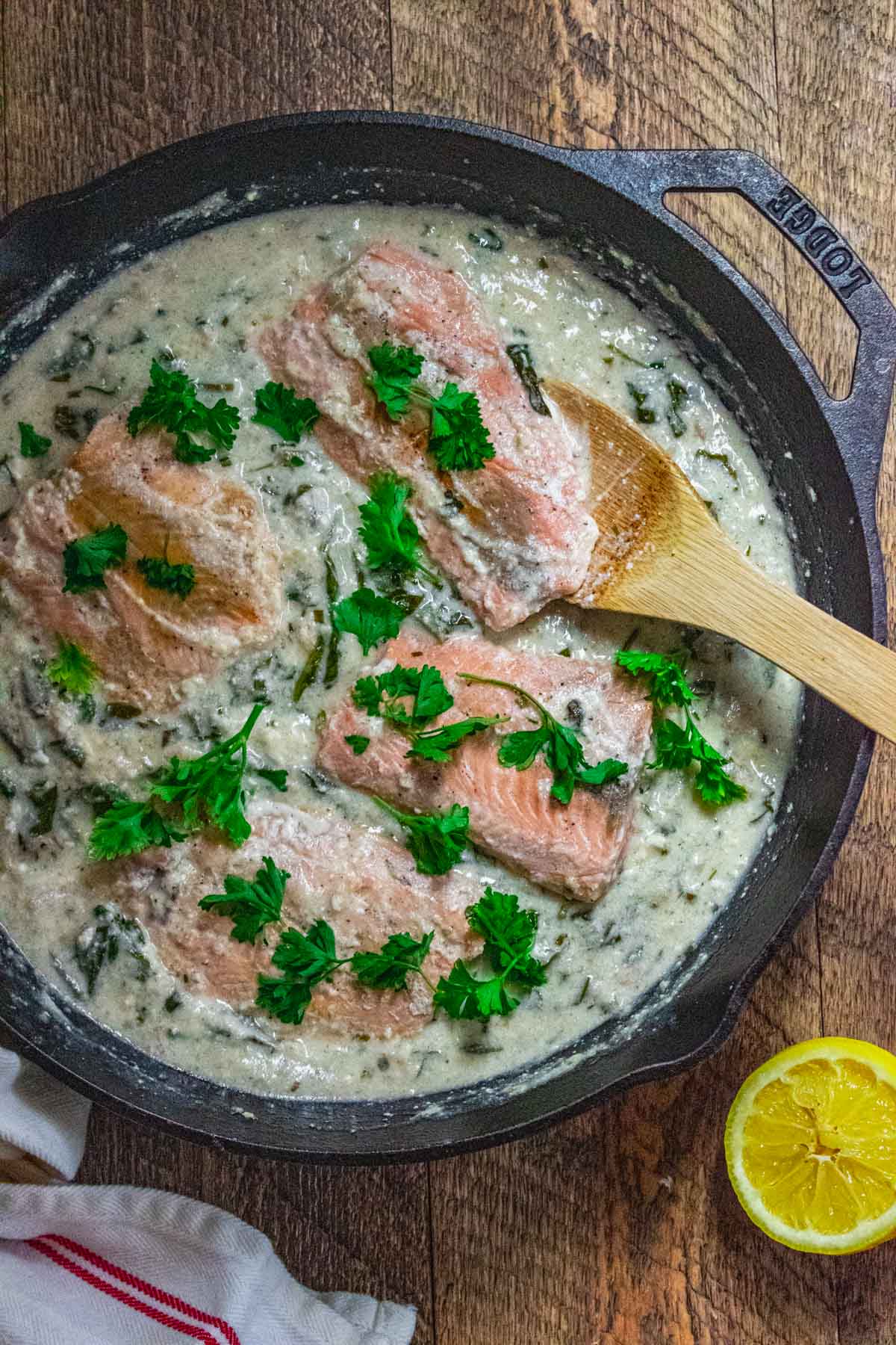 creamy garlic salmon in a white wine sauce with capers in a cast lodge iron skillet