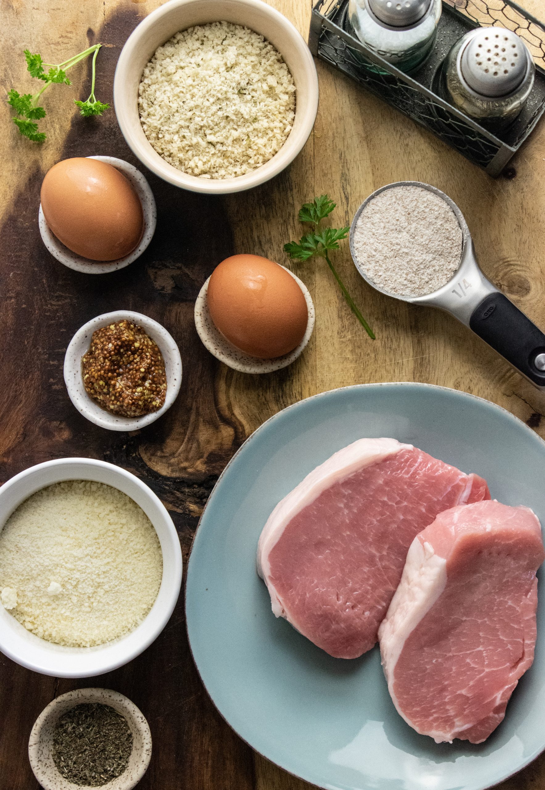 pork chop ingredients laid out on a wooden cutting board