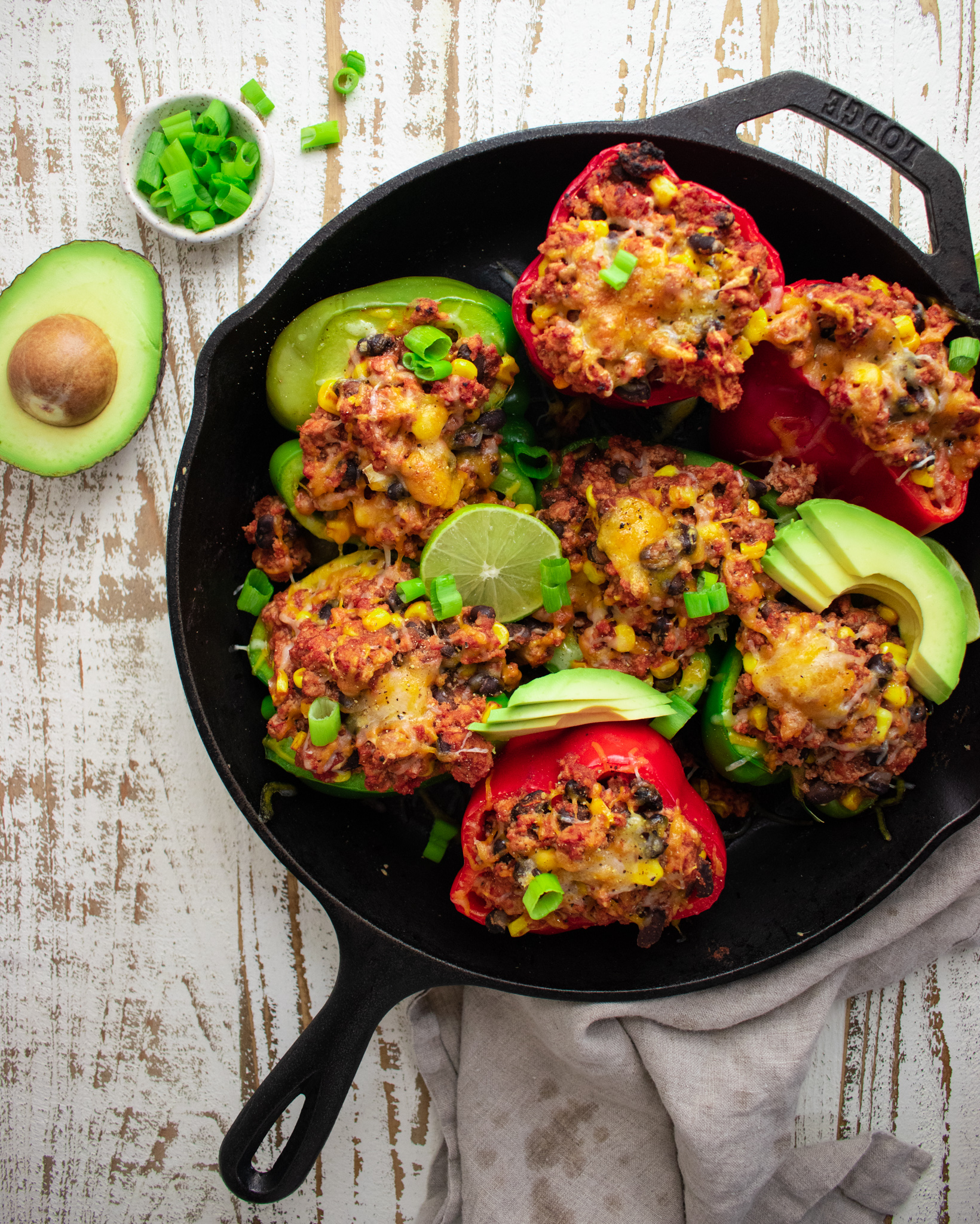 birds eye view of ground turkey stuffed peppers in a cast iron skillet