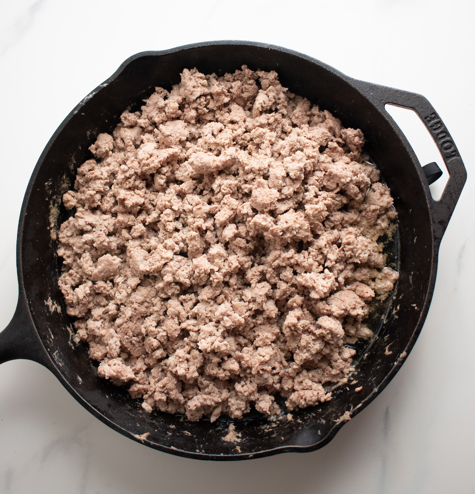 a cast iron skillet filled with cooked ground turkey