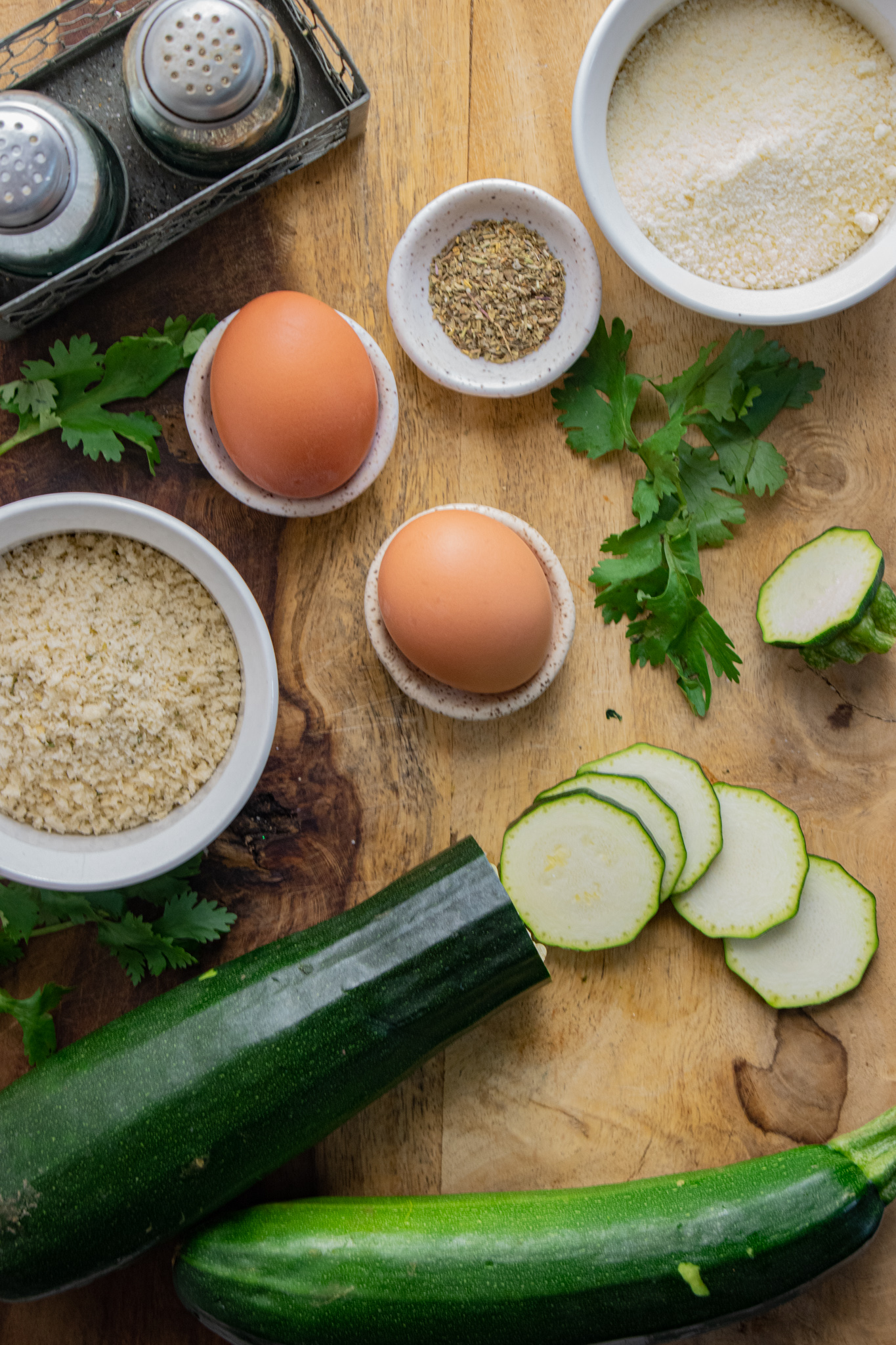 birds eye view of zucchini, eggs, panko, parmesan cheese, salt and pepper, and italian seasoning