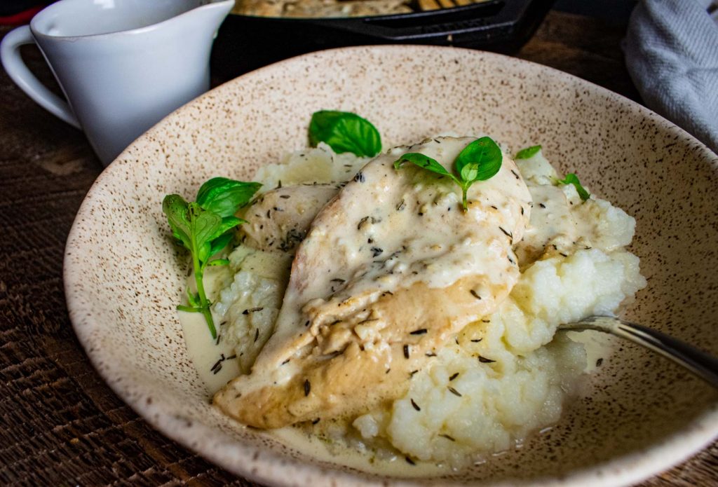 close up of cauliflower mash topped with dijon chicken