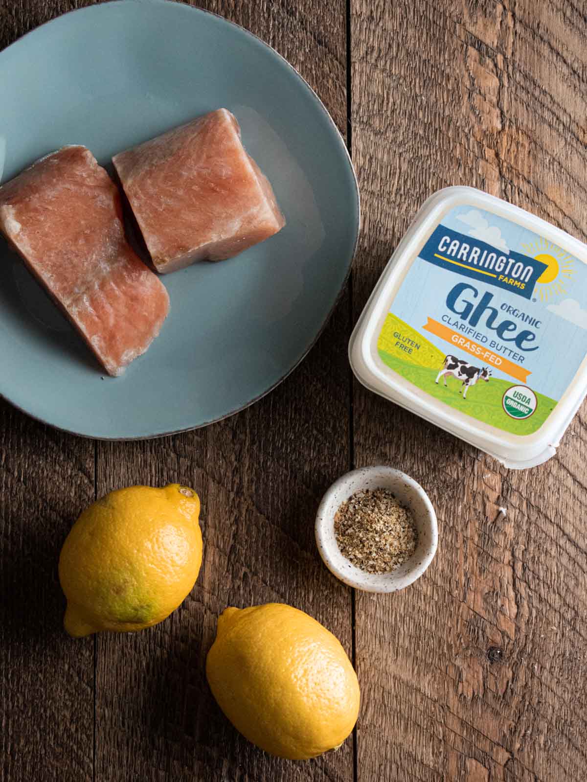 ingredients for easy baked salmon with lemon and butter on a wooden table