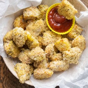 homemade baked chicken nuggets in a bowl with ketchup as dipping sauce