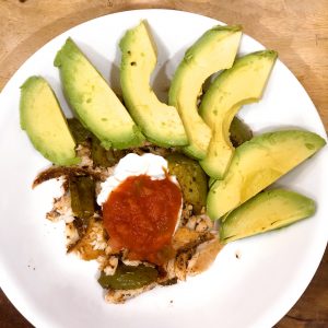 fish tacos in a white bowl with green bell peppers, avocado, plain greek yogurt, and salsa