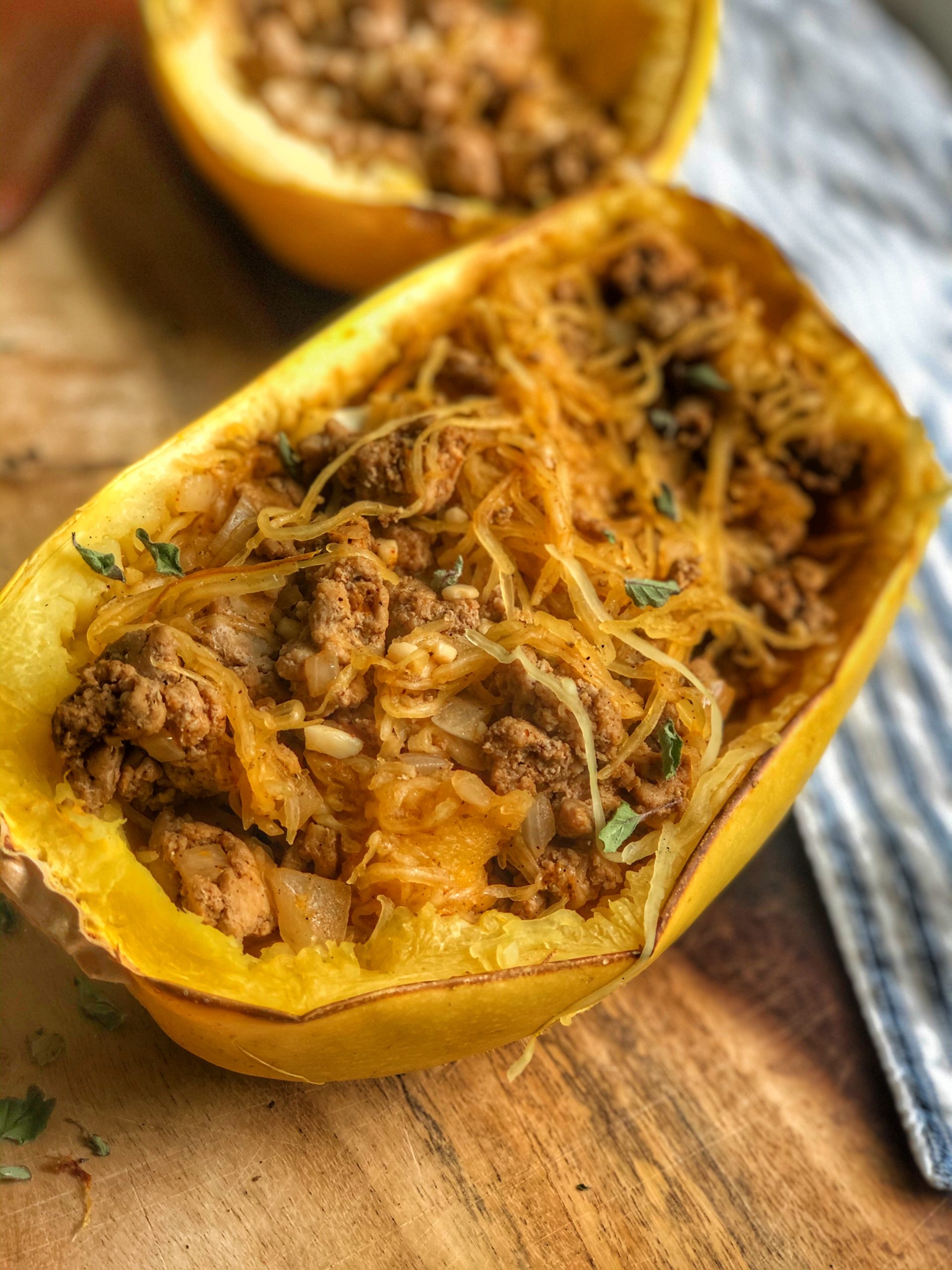 close up of spaghetti squash mexican boats on a wooden board