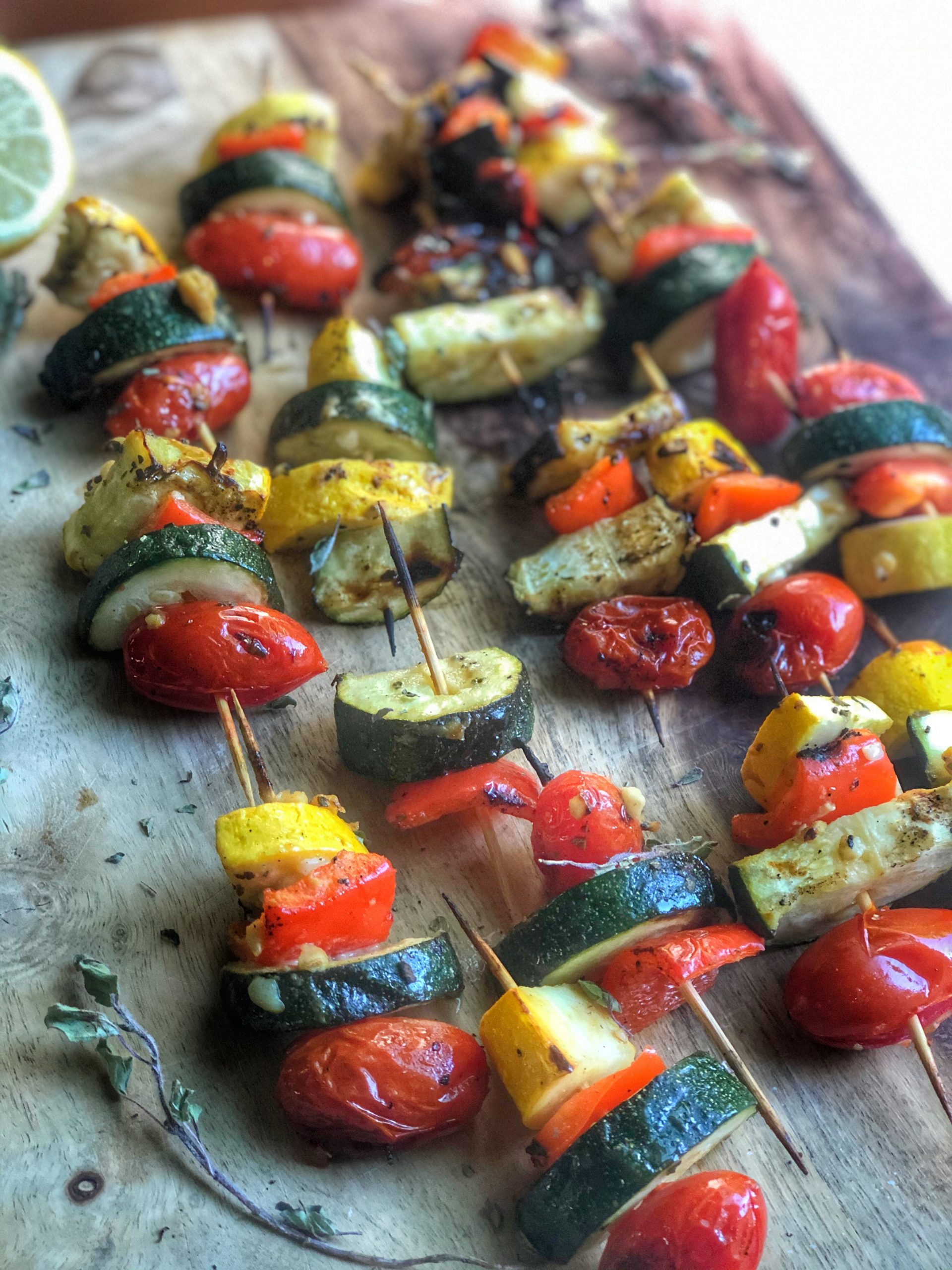 grilled veggie kabobs on a wooden board