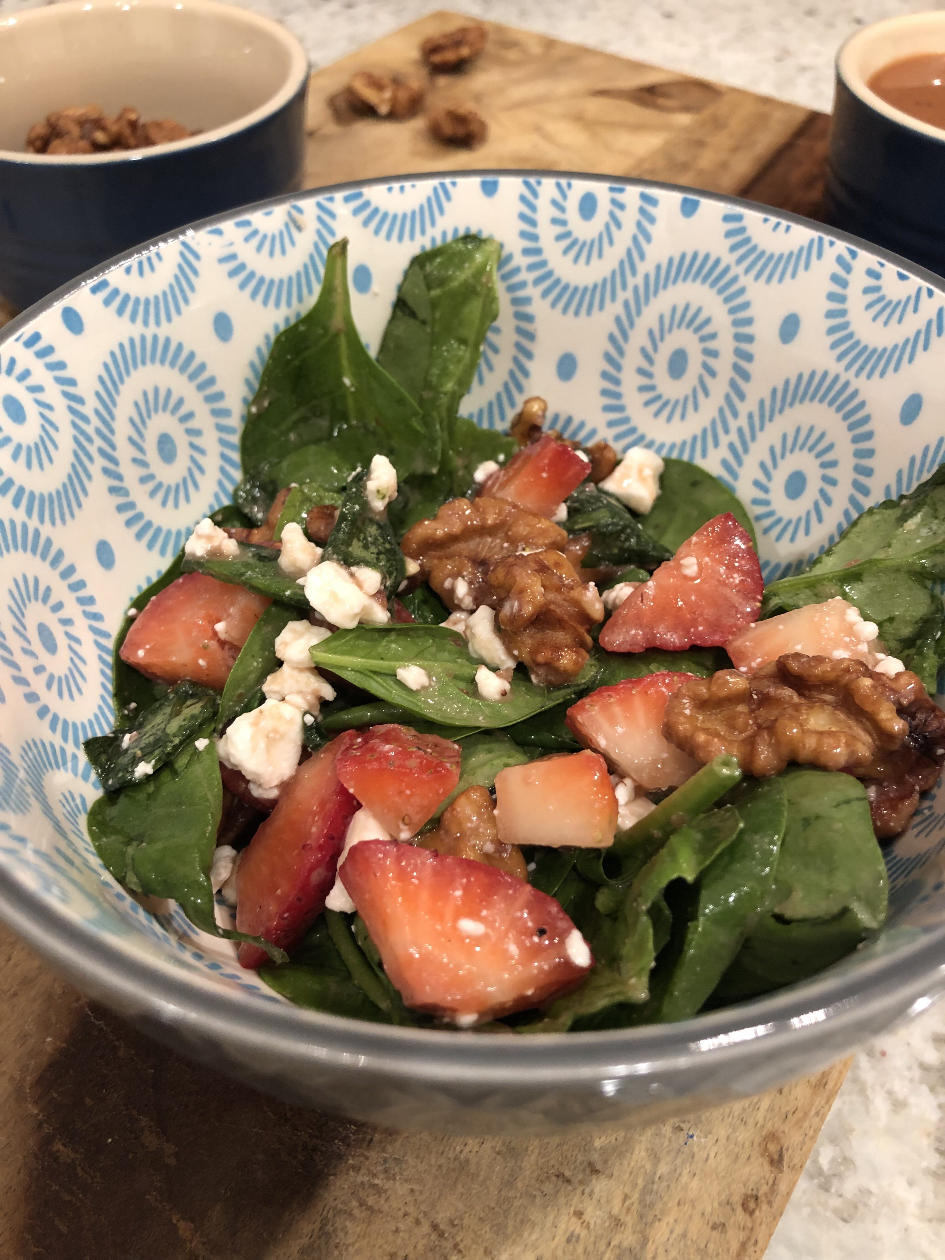 close up of the strawberry vinaigrette salad on a wooden board