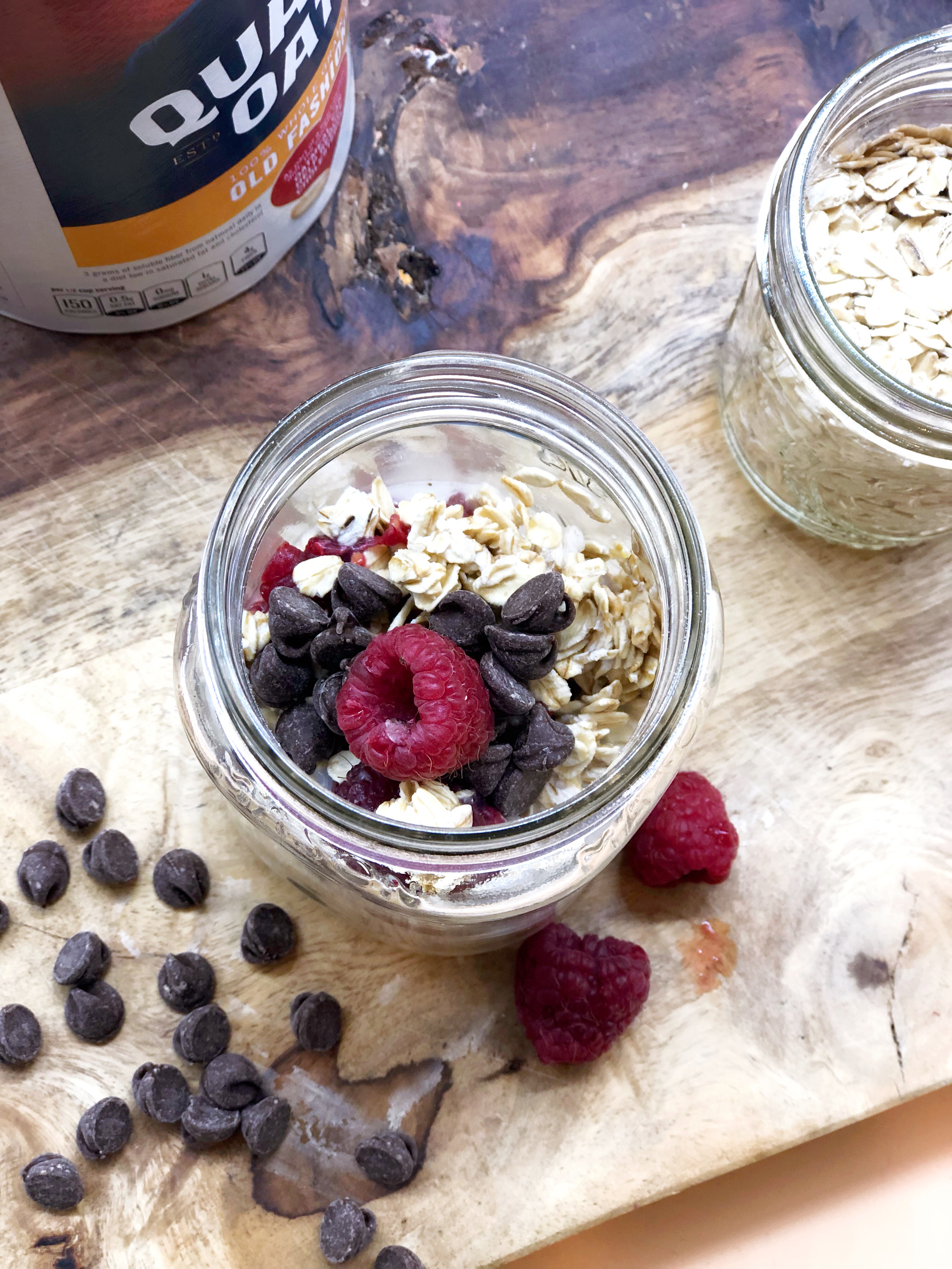 overnight oats on a wooden board in mason jars with scattered fruit