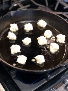cauliflower gnocchi cooking on a frying pan