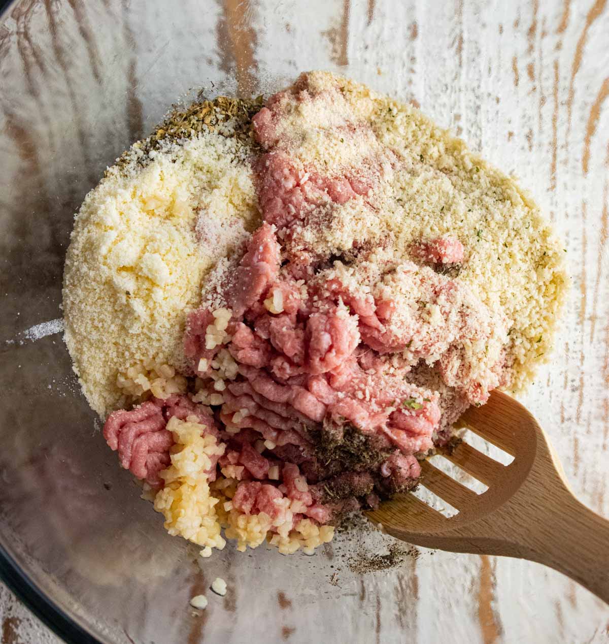 Step 2 for this recipe is adding ground turkey, egg, panko, parmesan cheese, garlic, and all the seasonings to a mixing bowl.