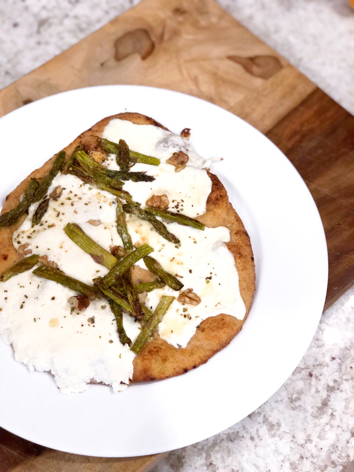 birds eye view of asparagus and naan mozzarella pizza