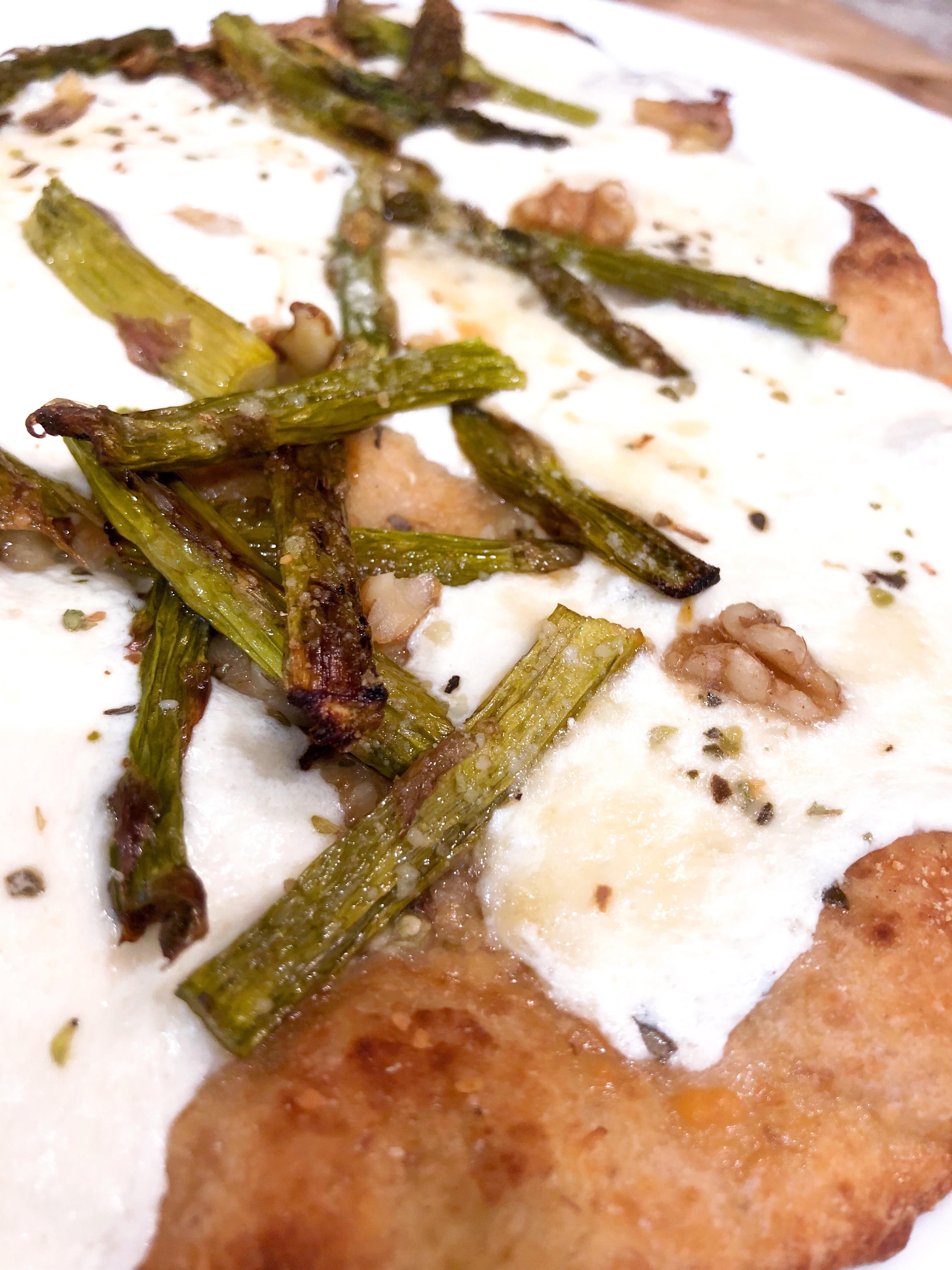 close up of naan asparagus pizza