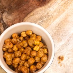 bowl of roasted chickpeas on a wooden board