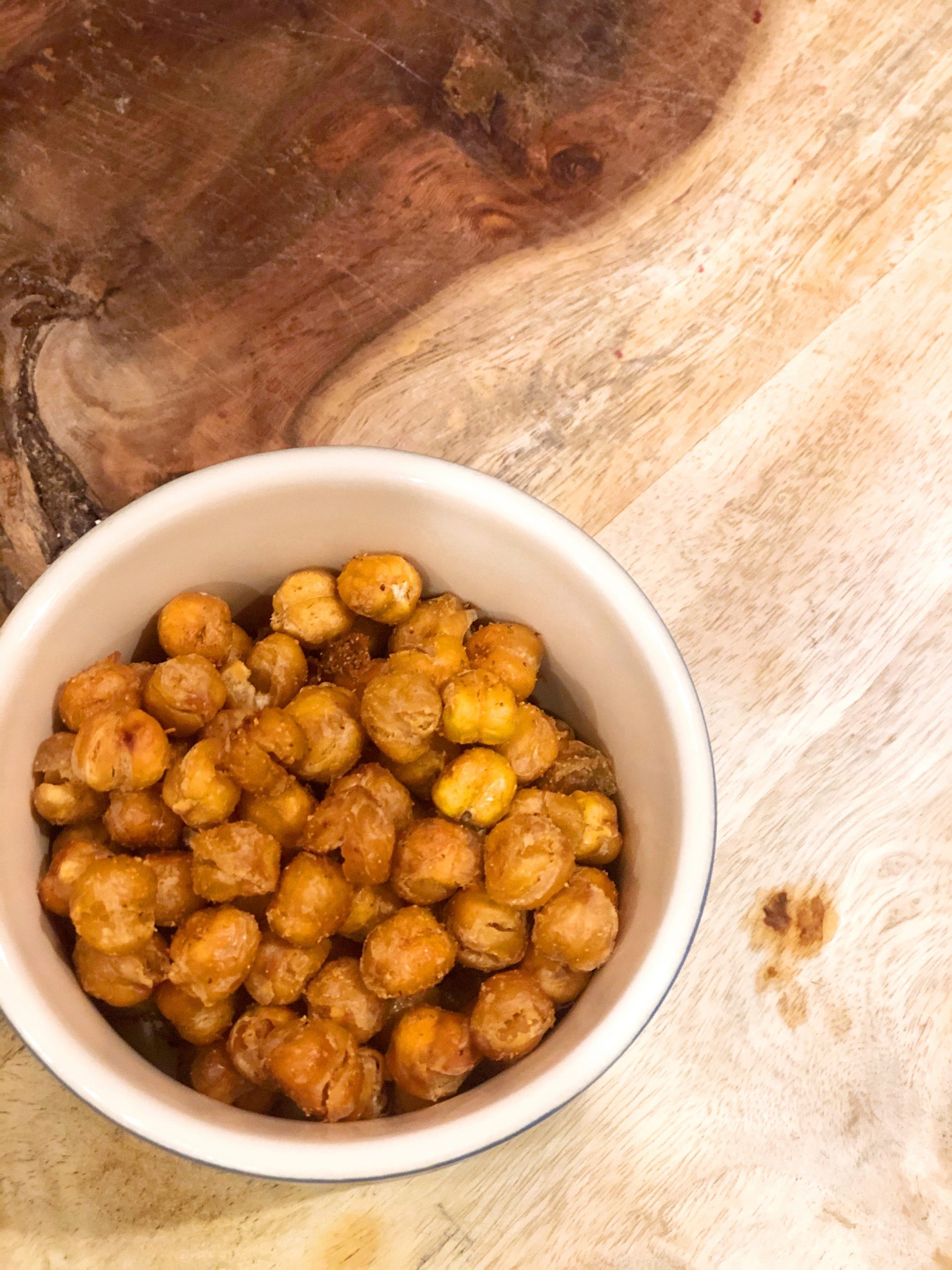 bowl of roasted chickpeas on a wooden board