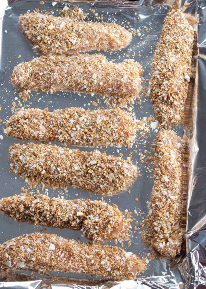 coconut crusted chicken on a baking tray lined with foil