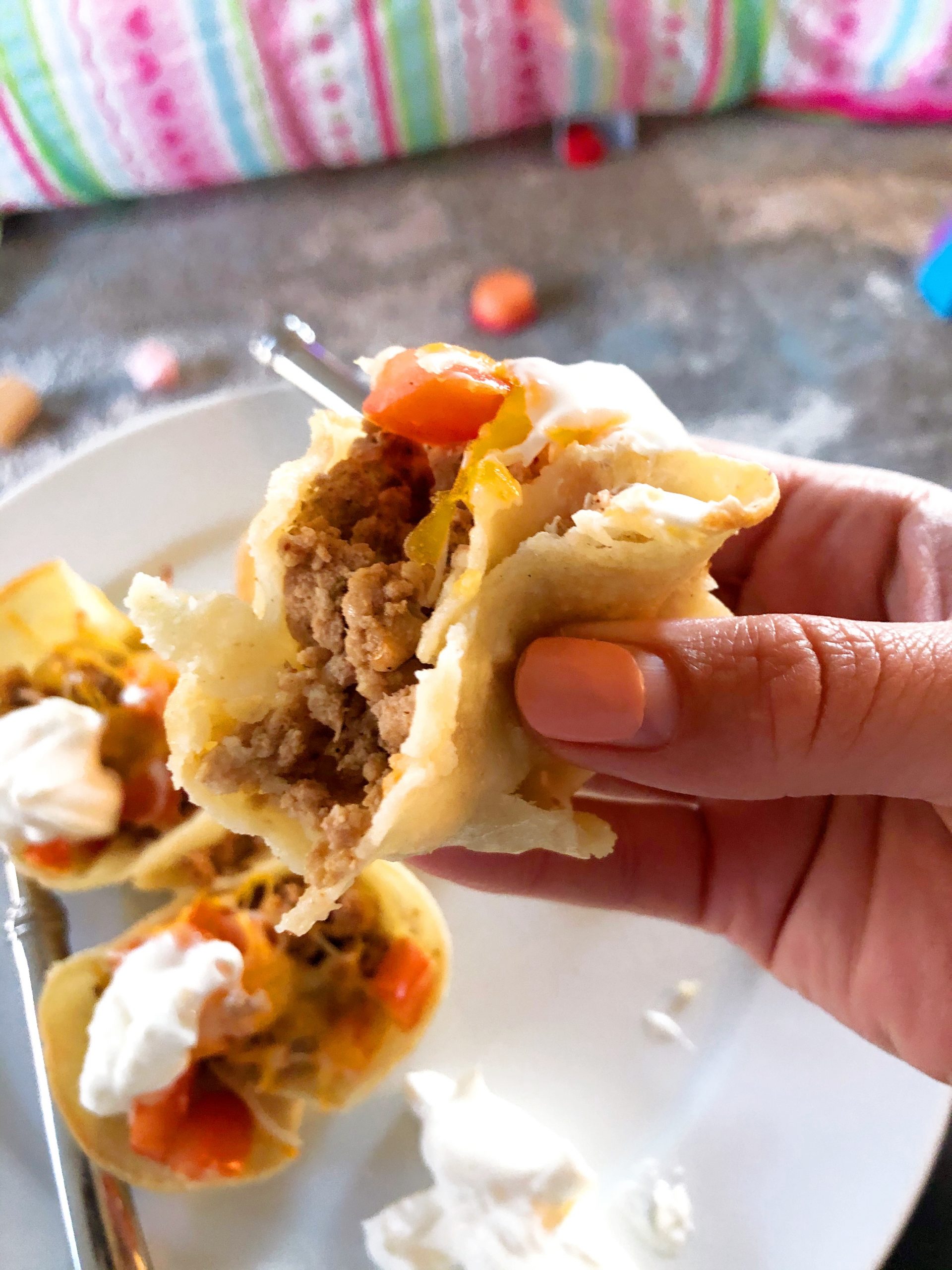 a hand eating a ground turkey cupcake