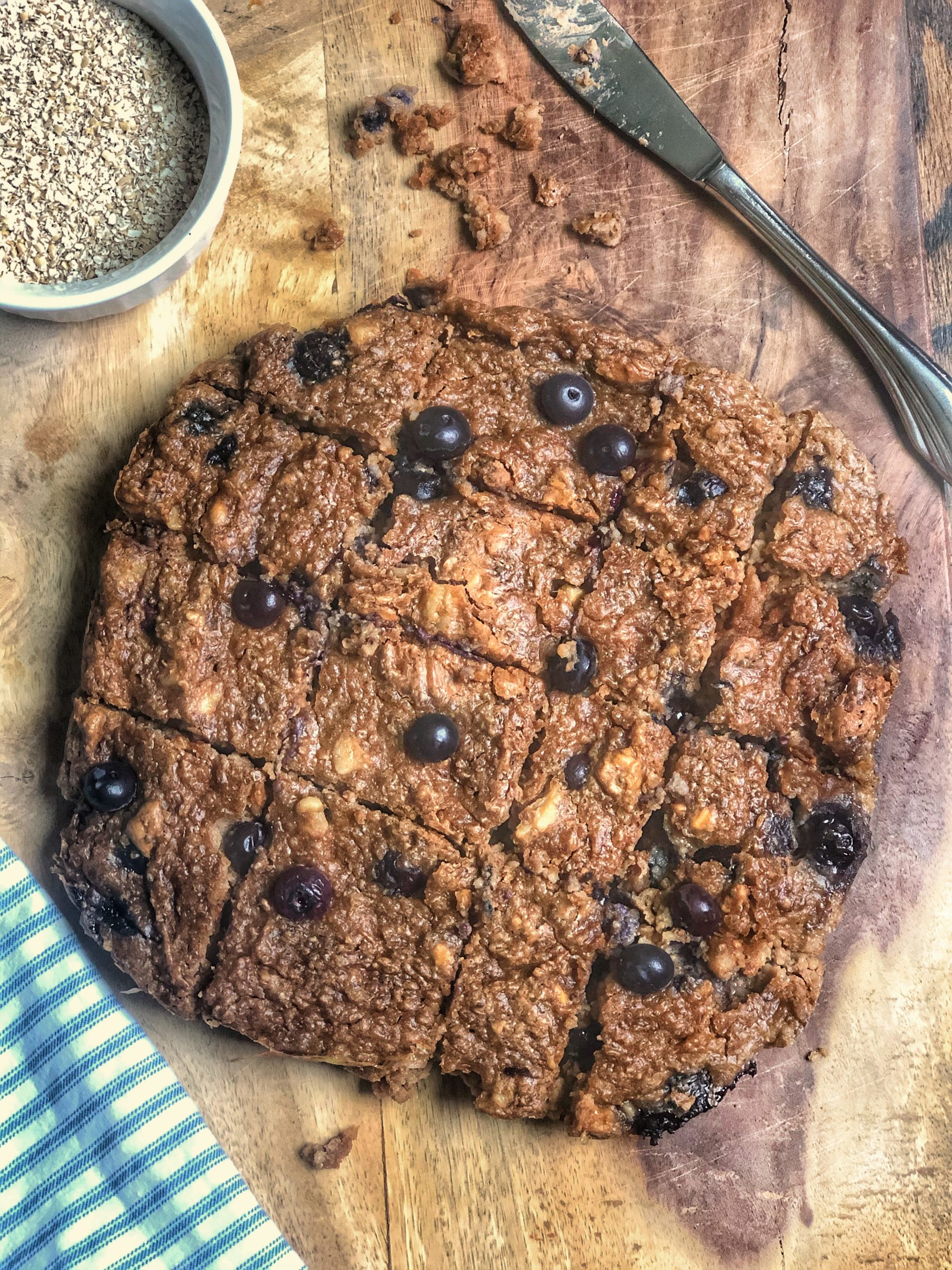 peanut butter blueberry oat energy snacks on a wooden board with a blue napkin