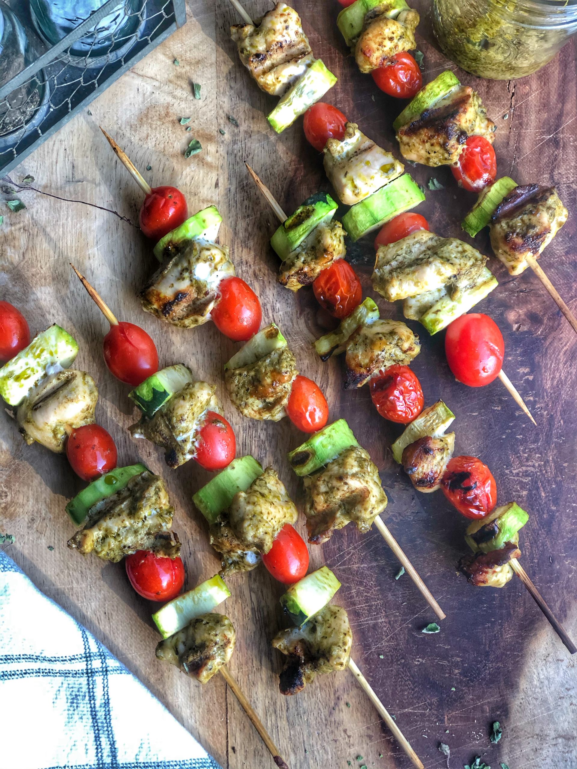 grilled chicken pesto skewers on a wooden board