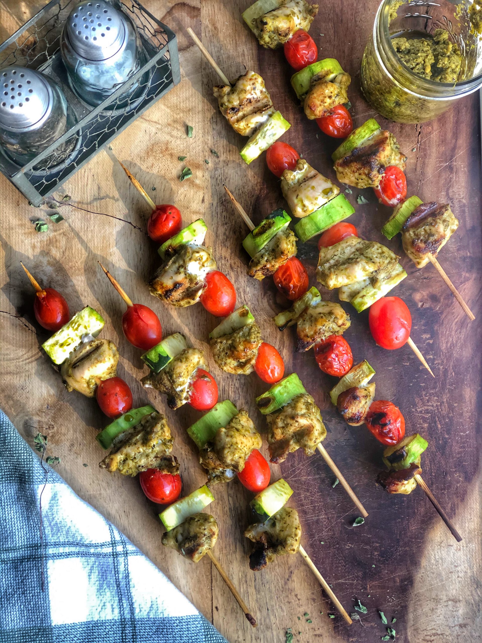 grilled chicken pesto skewers on a wooden board