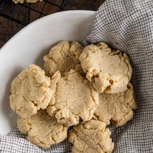 almond flour cookies on a white plate with a checkered napkin