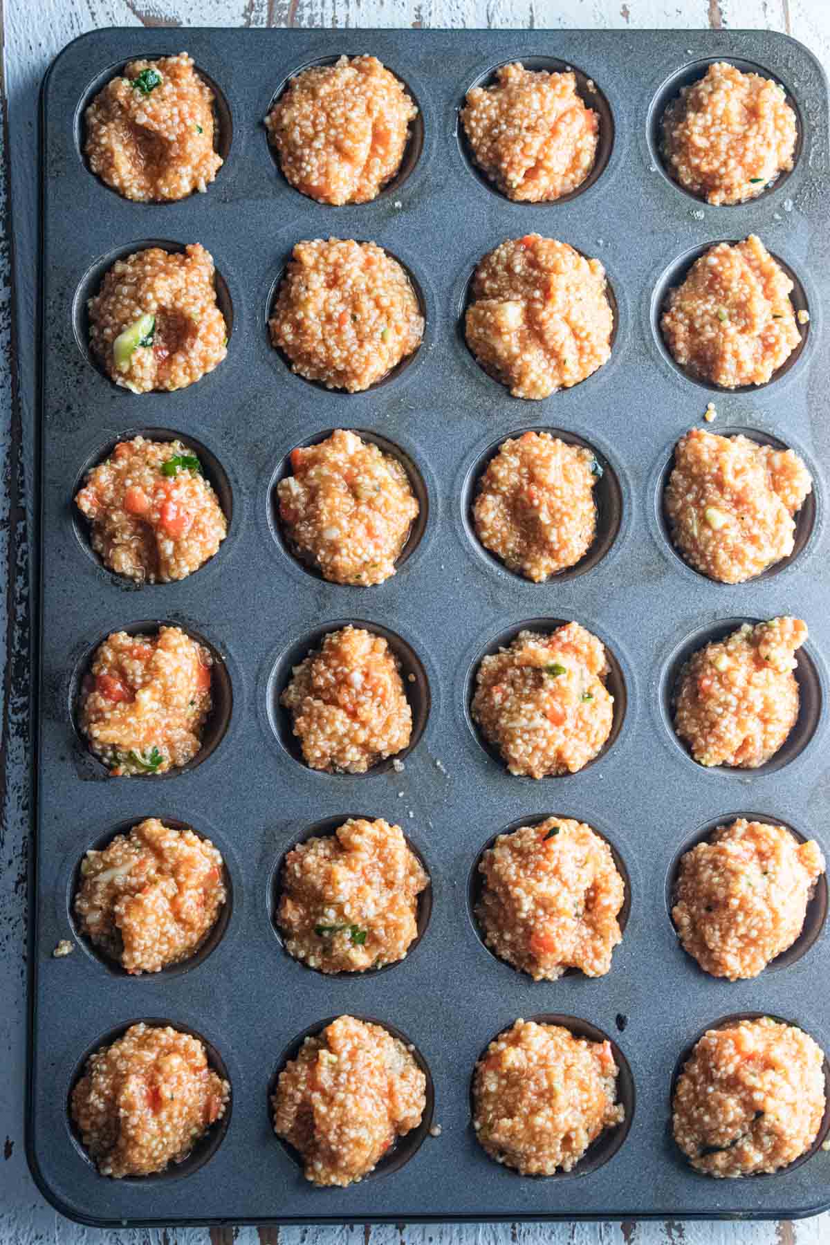 Step 3 - a mini-muffin tray filled up with the buffalo quinoa mixture.