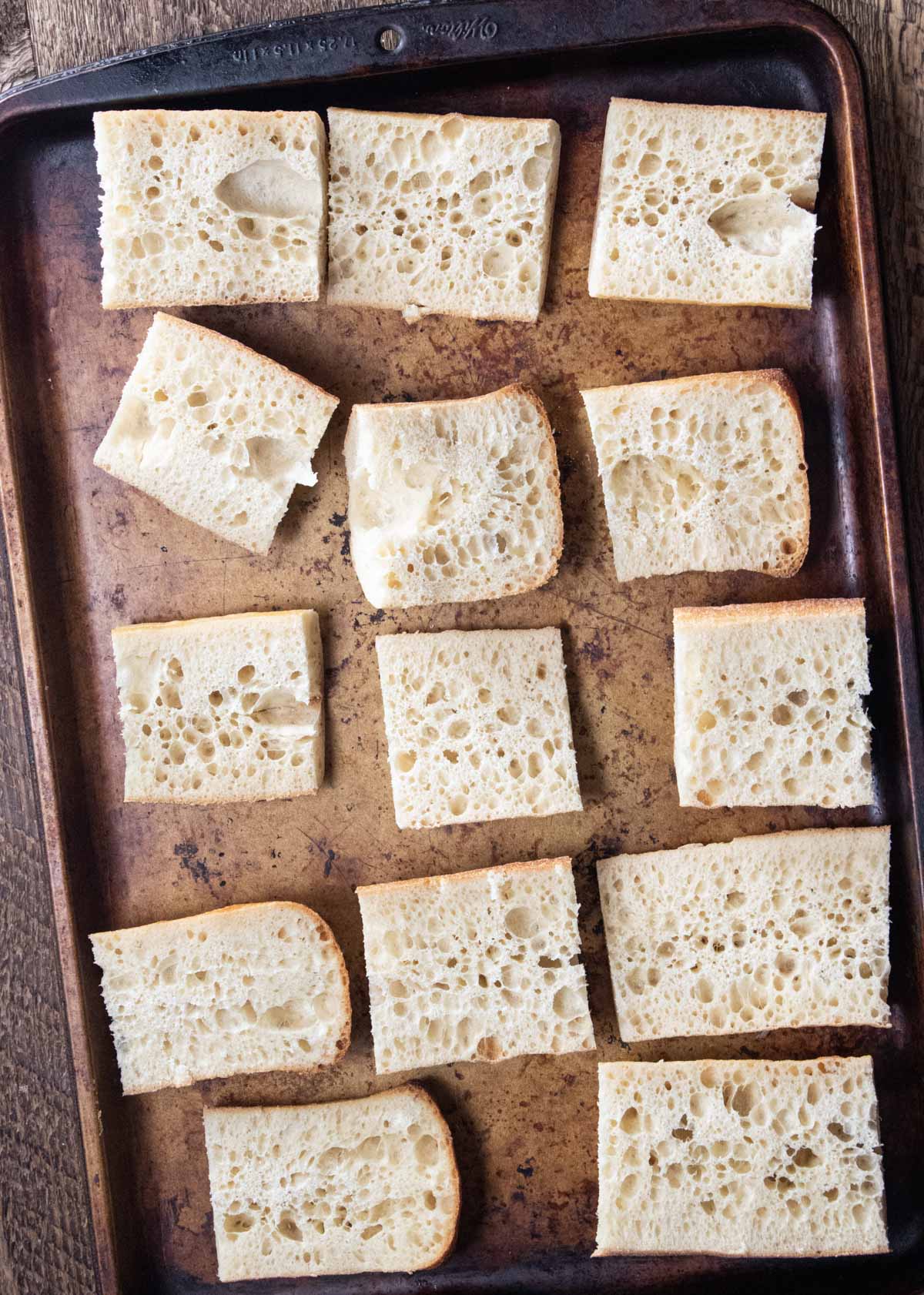 step 1  - slices of thin crusty bread on a baking sheet