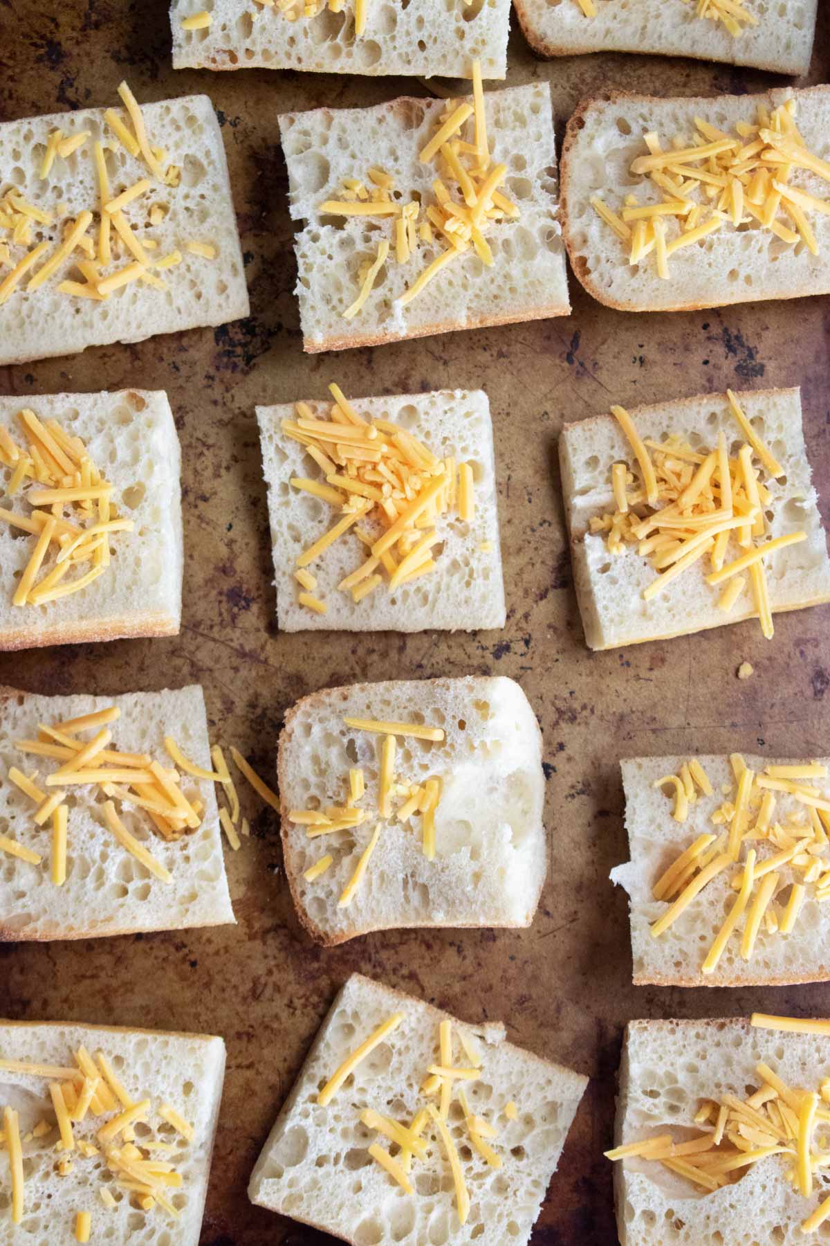 step 3 - cheese on top of sliced baguettes