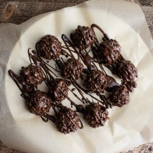 birds eye view of chocolate peanut butter balls on a white plate