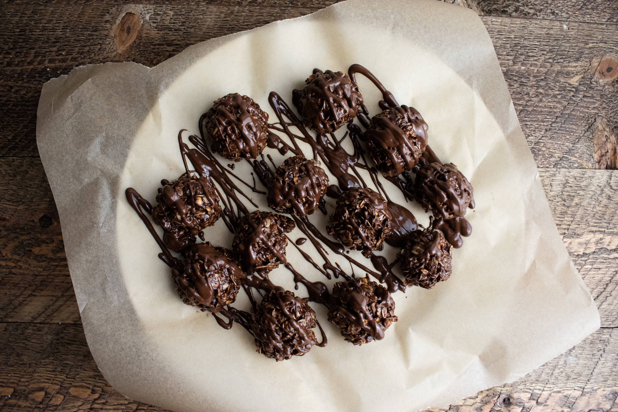 birds eye view of chocolate peanut butter balls on a white plate