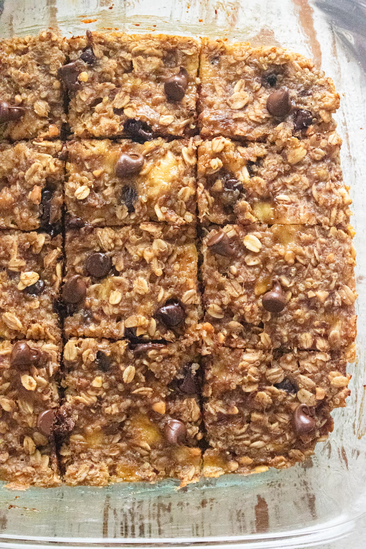 A close up of healthy breakfast bars in a clear glass dish.