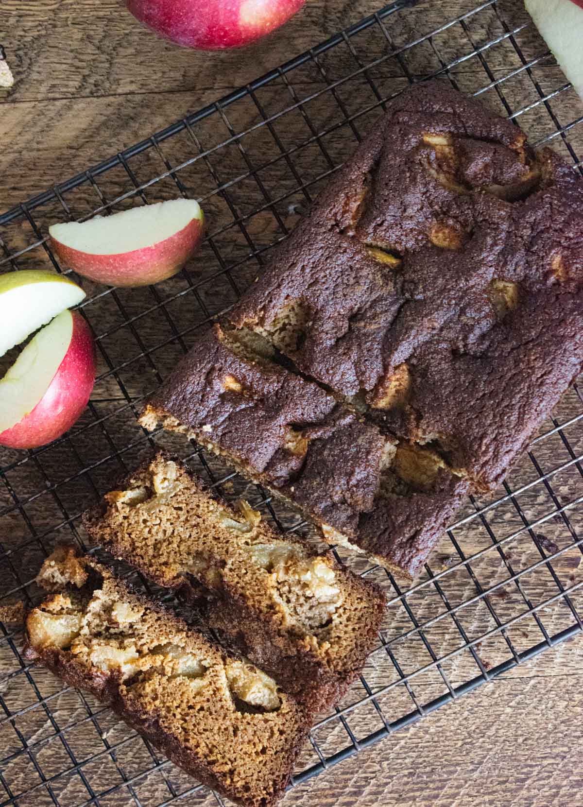 healthy apple bread sliced into pieces on a cooling rack