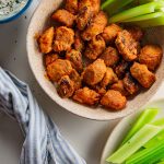 birds eye view of homemade buffalo cauliflower gnocchi in a cream colored bowl