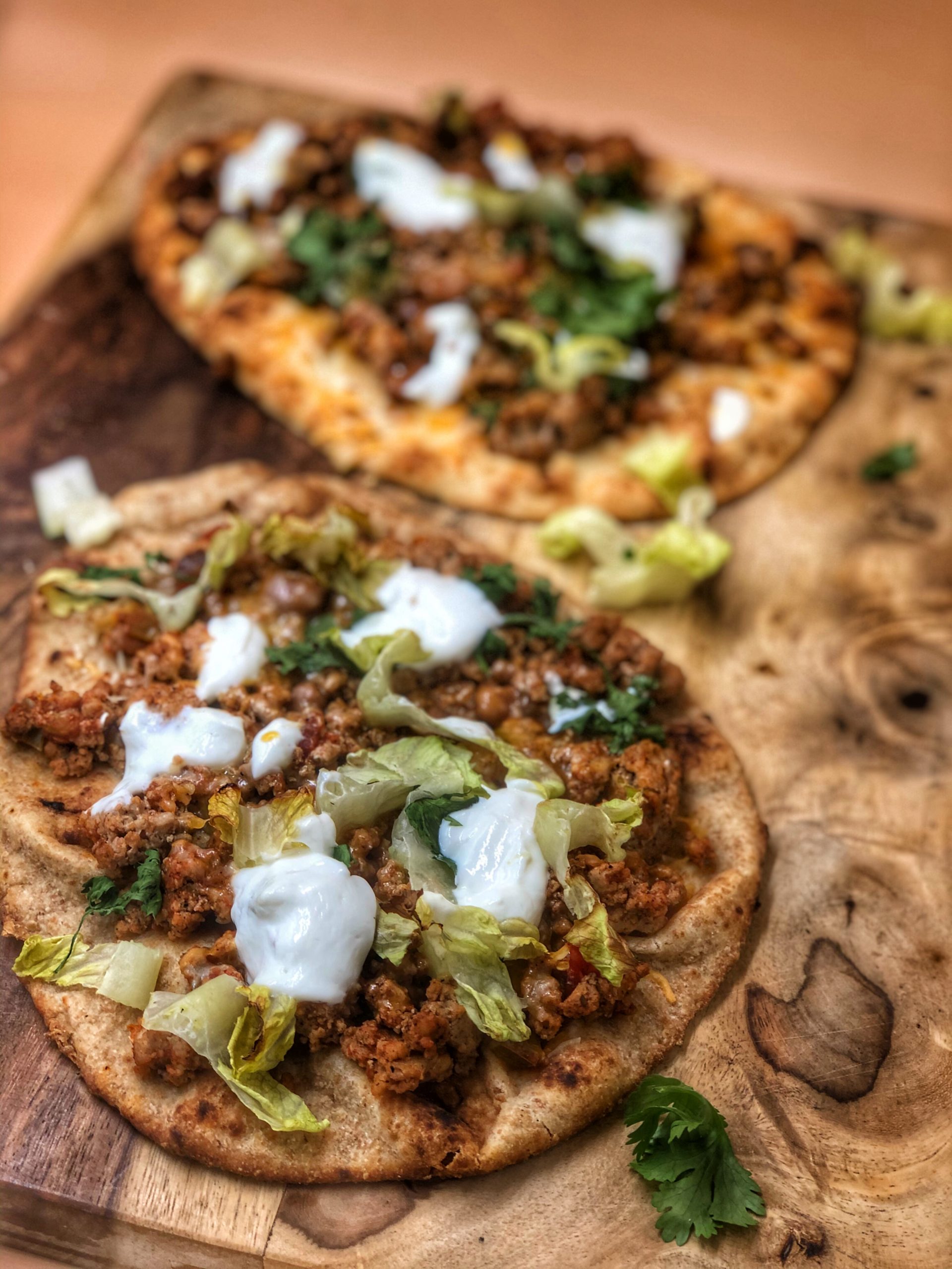 taco naan pizza on a wooden cutting board