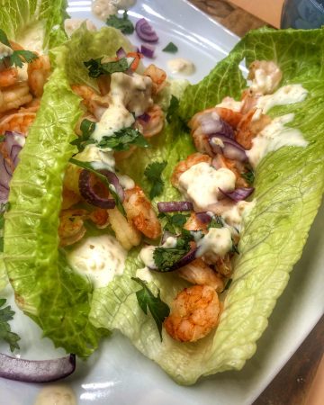 close up of honey adobo shrimp tacos