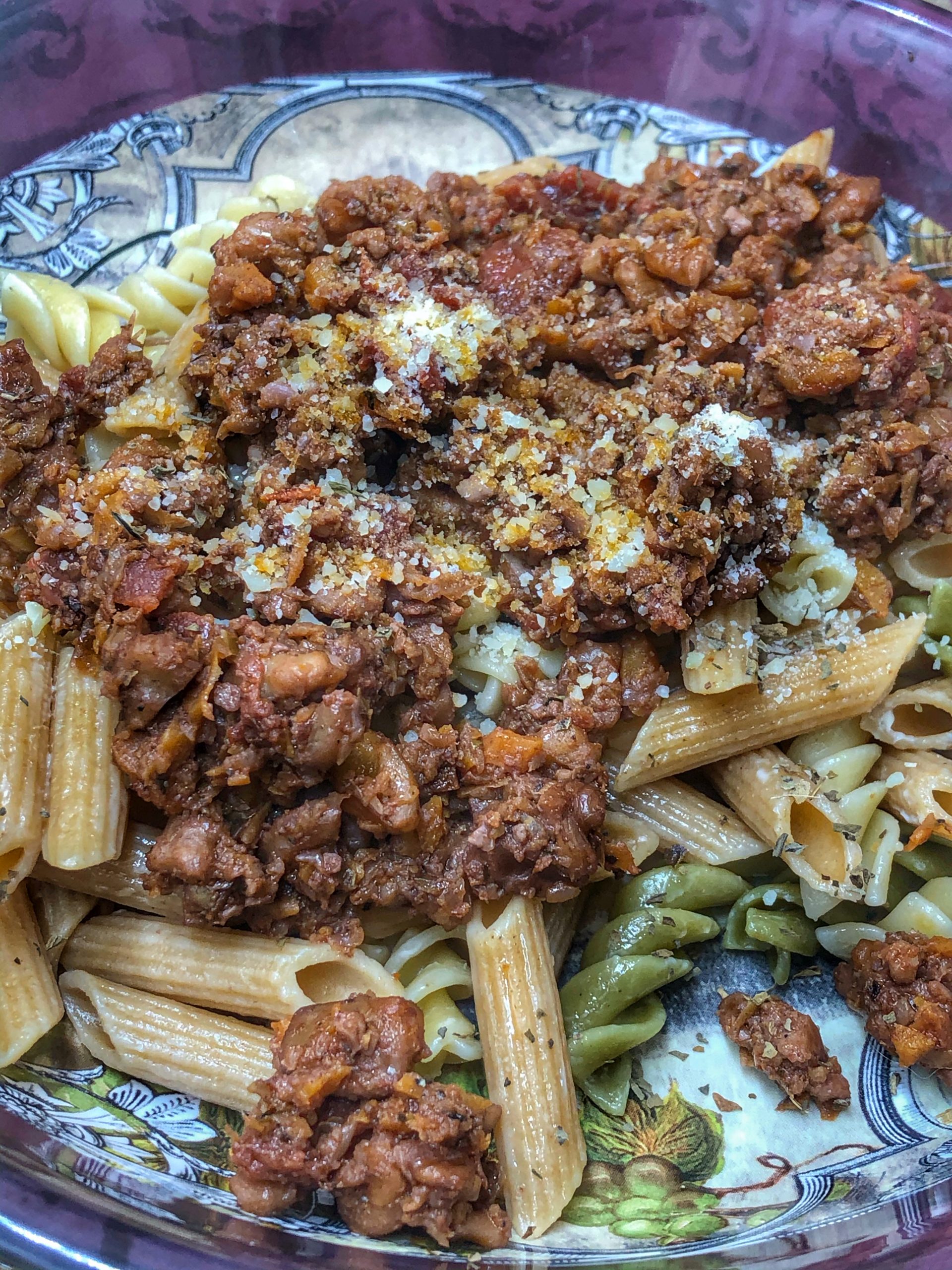 close up of walnut bolognese over whole wheat pasta