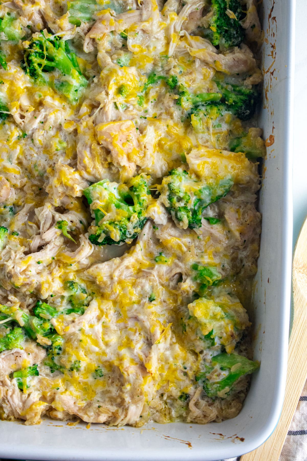 Birds eye view of a chicken broccoli and rice casserole in a white dish.