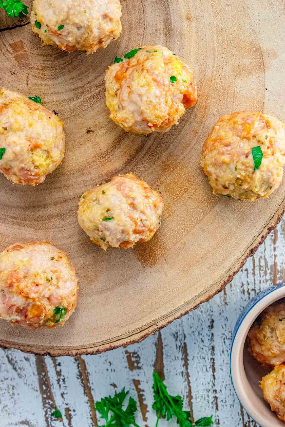 close up of chicken meatballs on a wooden board