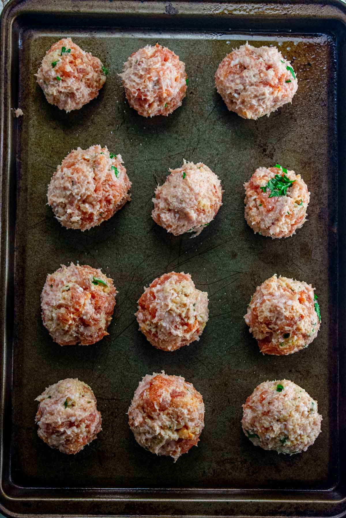 Step 4 - meatballs formed and placed on a prepared baking dish.