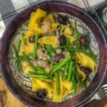 asparagus olives and pancetta paradelle birds eye view in a maroon bowl