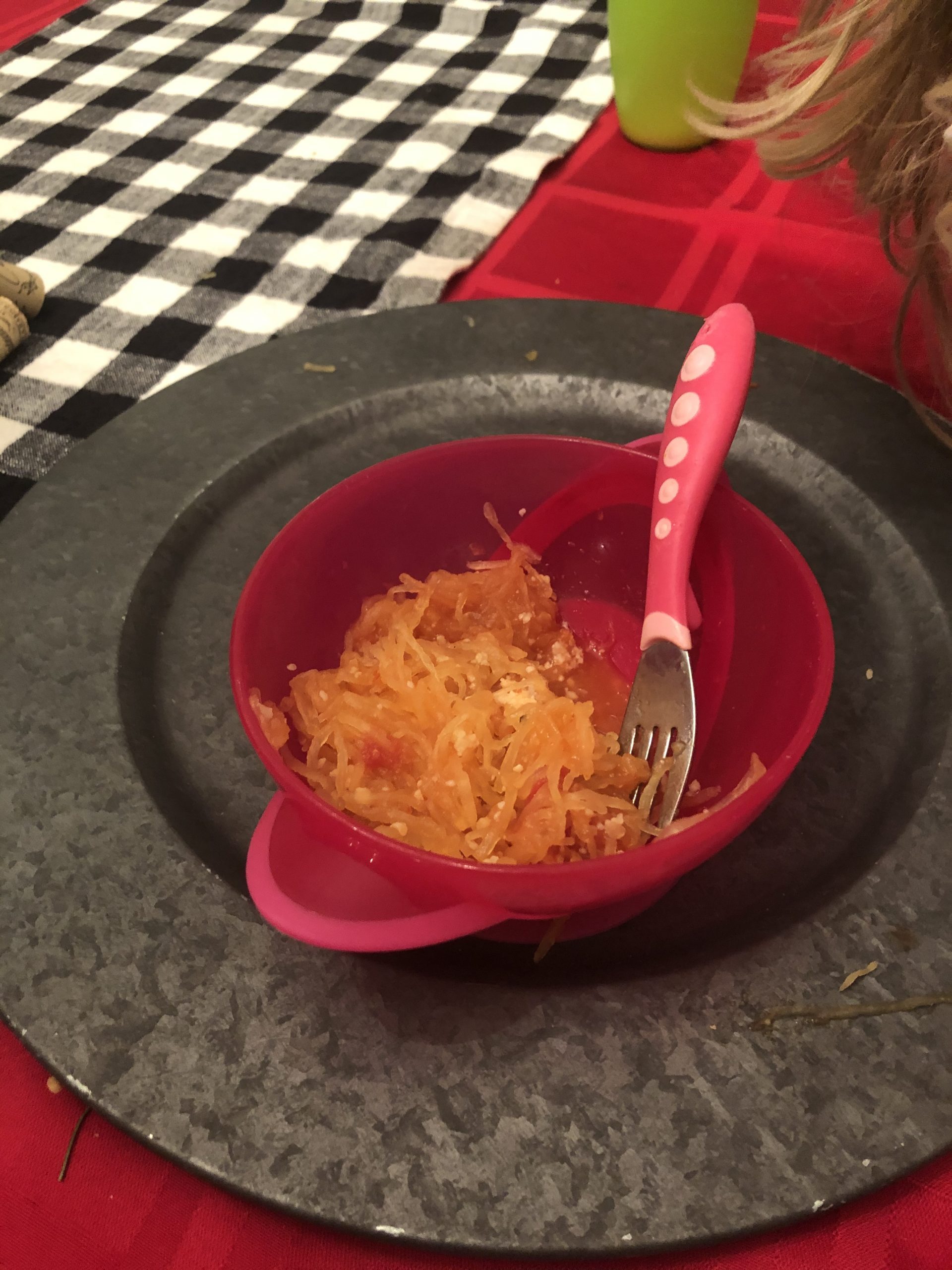 spaghetti squash in a pink bowl with a little kids pink fork