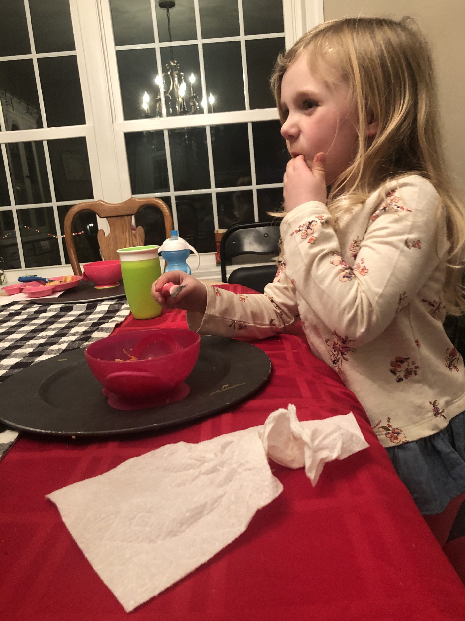 a little blonde girl eating spaghetti squash for dinner 