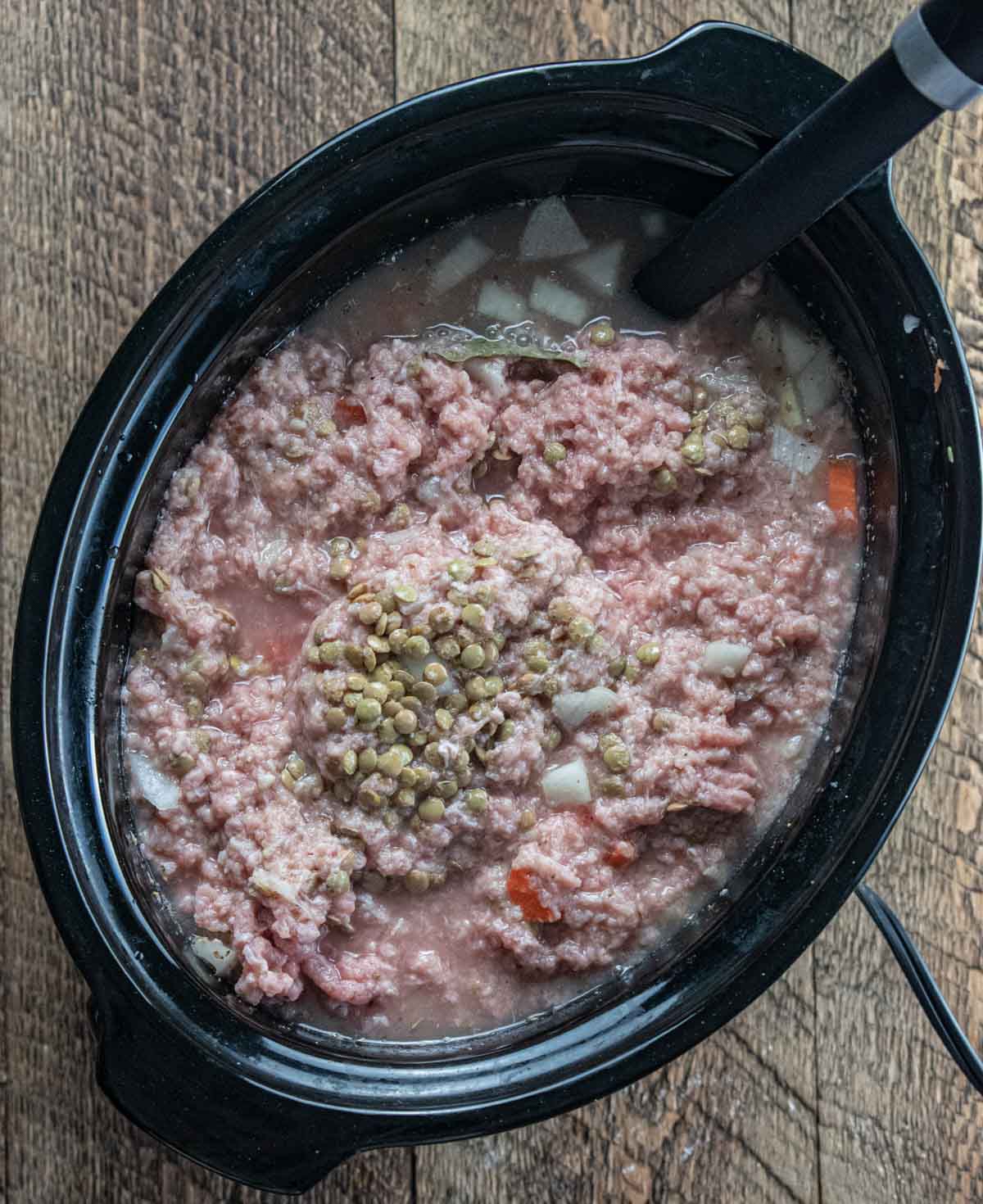 ingredients in a crockpot ready to be cooked