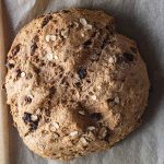 irish soda bread on a sheet of parchment paper right out of the oven