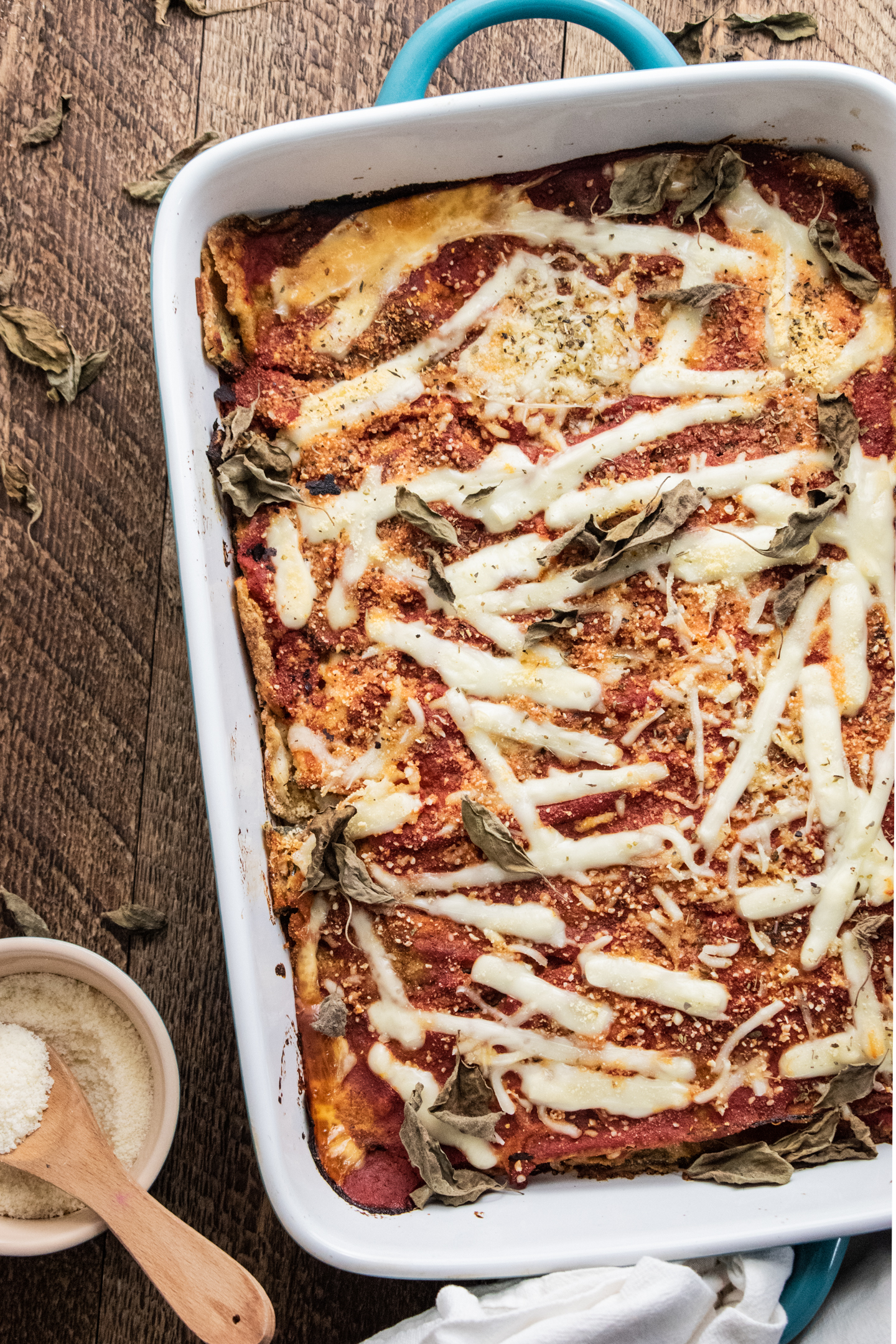 zucchini parmesan in a 9 x 13 inch baking dish on a wooden table