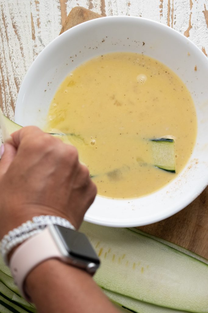 zucchini being dipped in egg