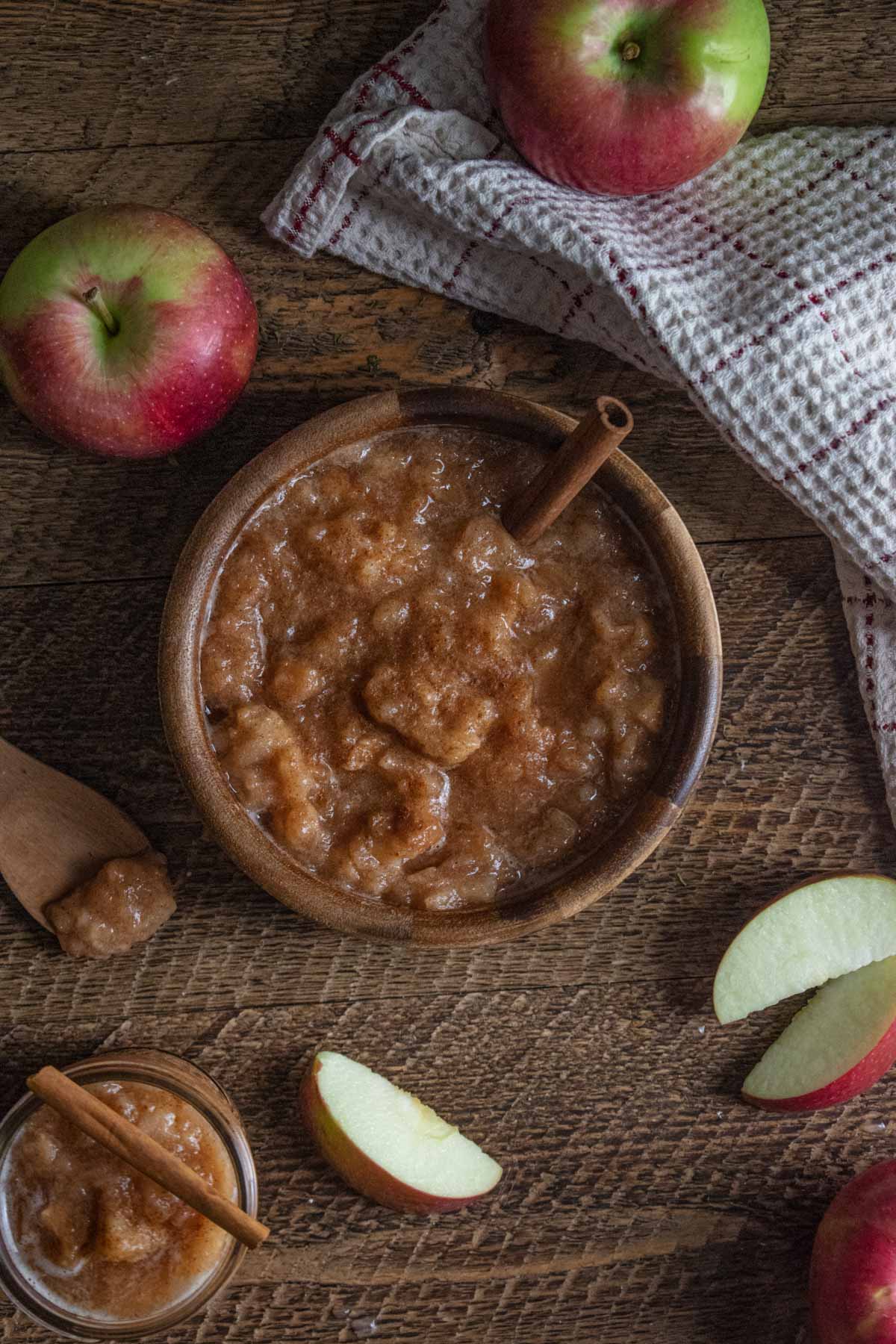 homemade crockpot applesauce in a wooden bowl on a wooden board